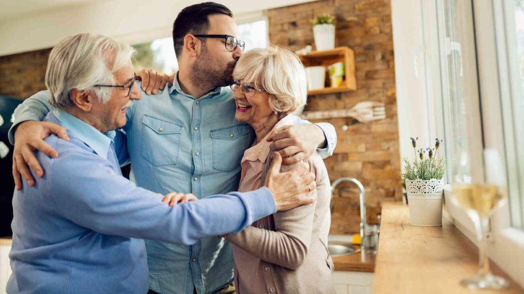 Parents giving their son gift money for a home down payment