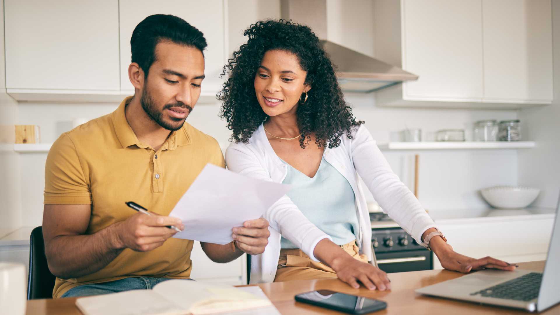 Couple using computer to save money for a home purchase