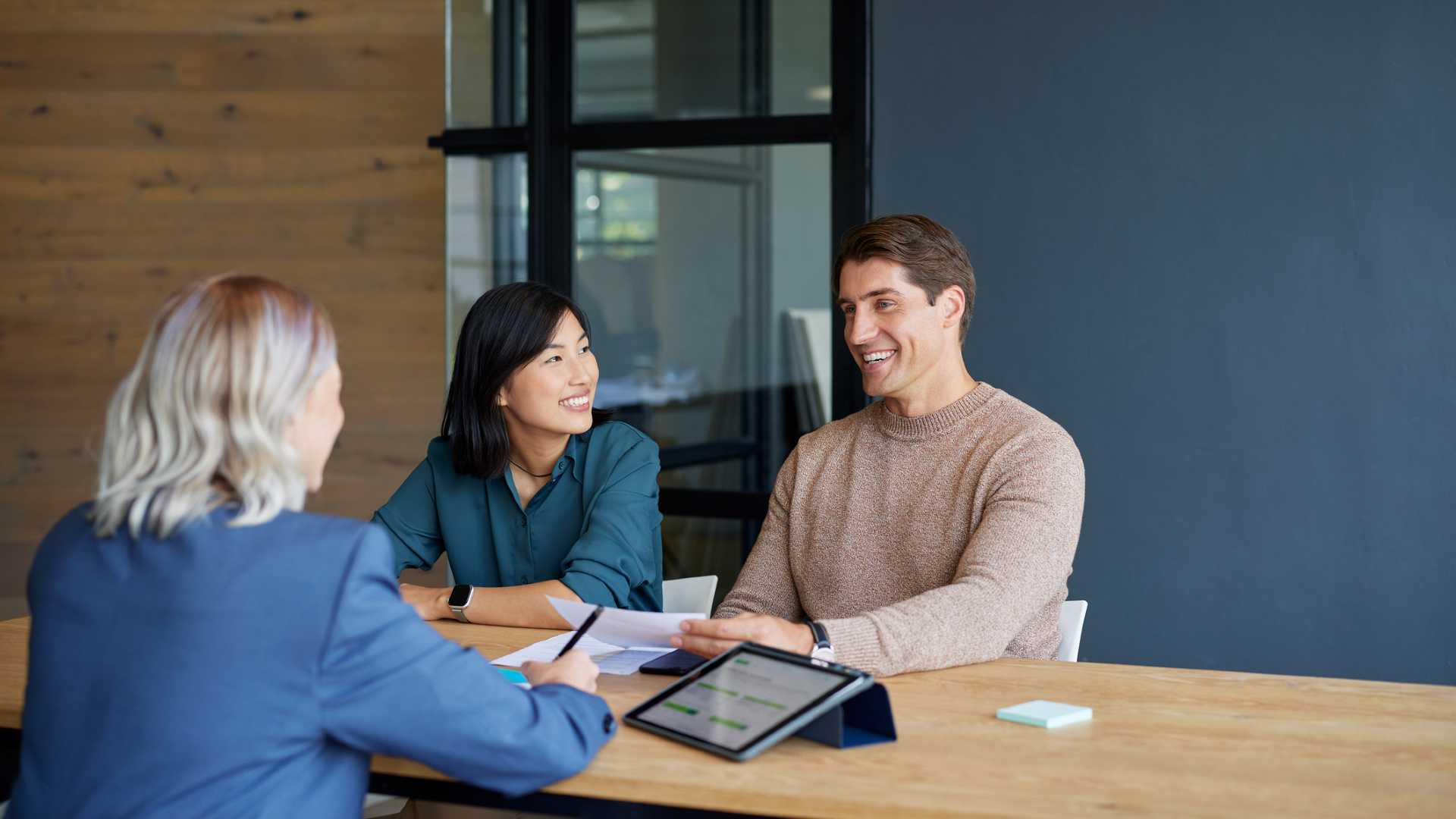 loan officer speaking to a couple about refinancing their home