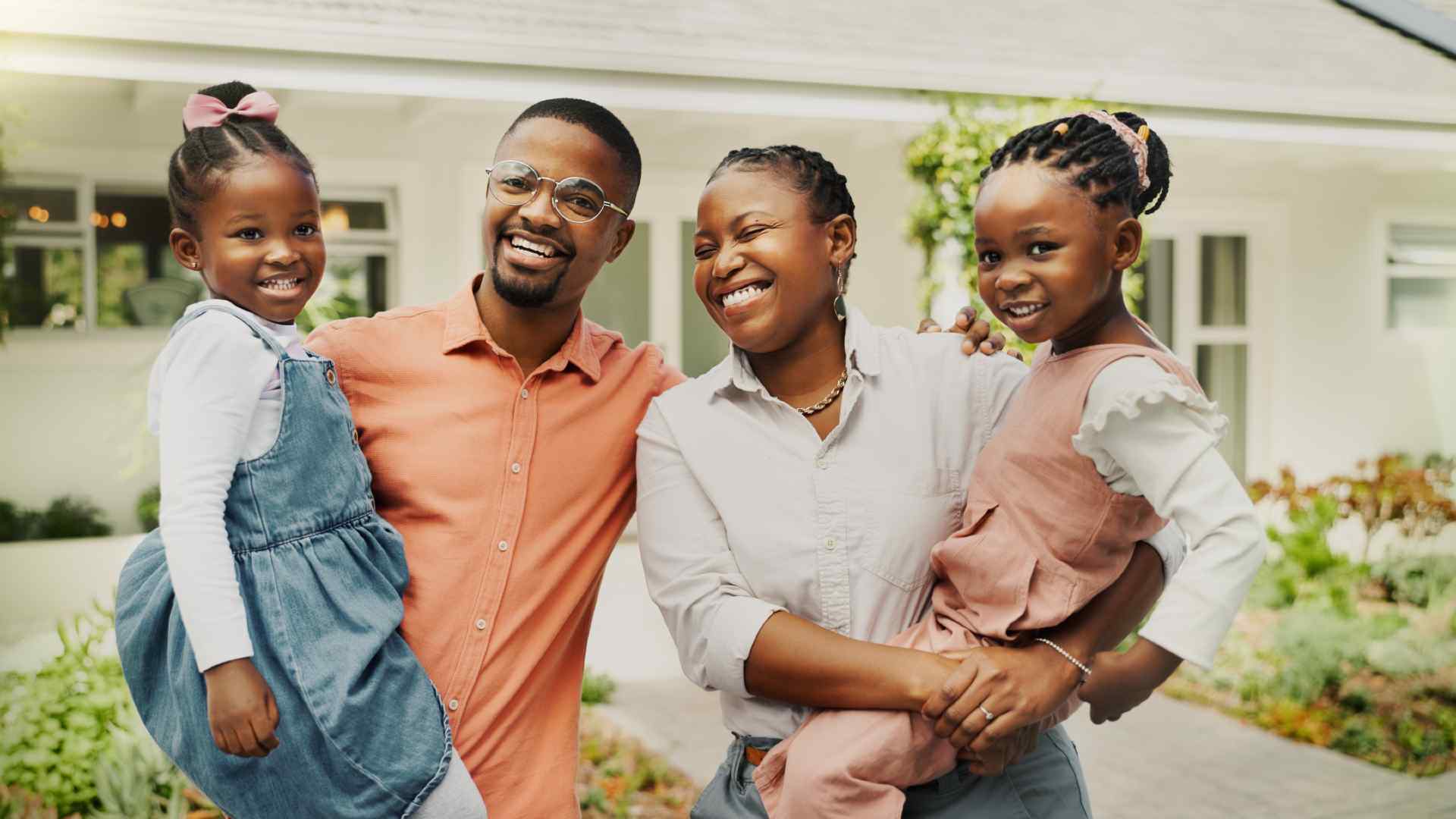 Black family outside of heir new home