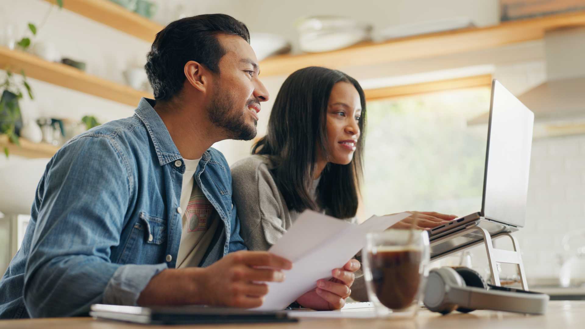 Homebuyers organizing their financial documents for their mortgage application.