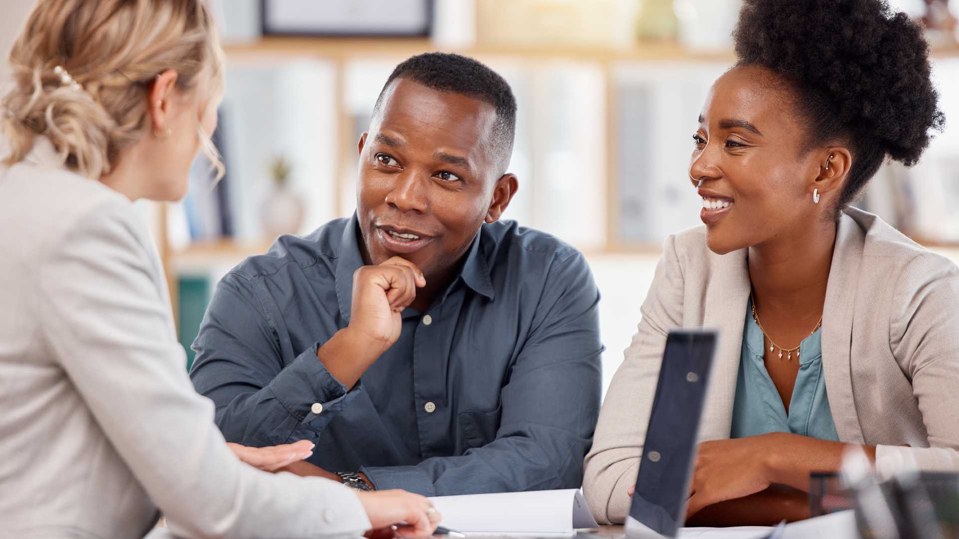 Loan officer discussing mortgage programs with aspiring homebuyers,